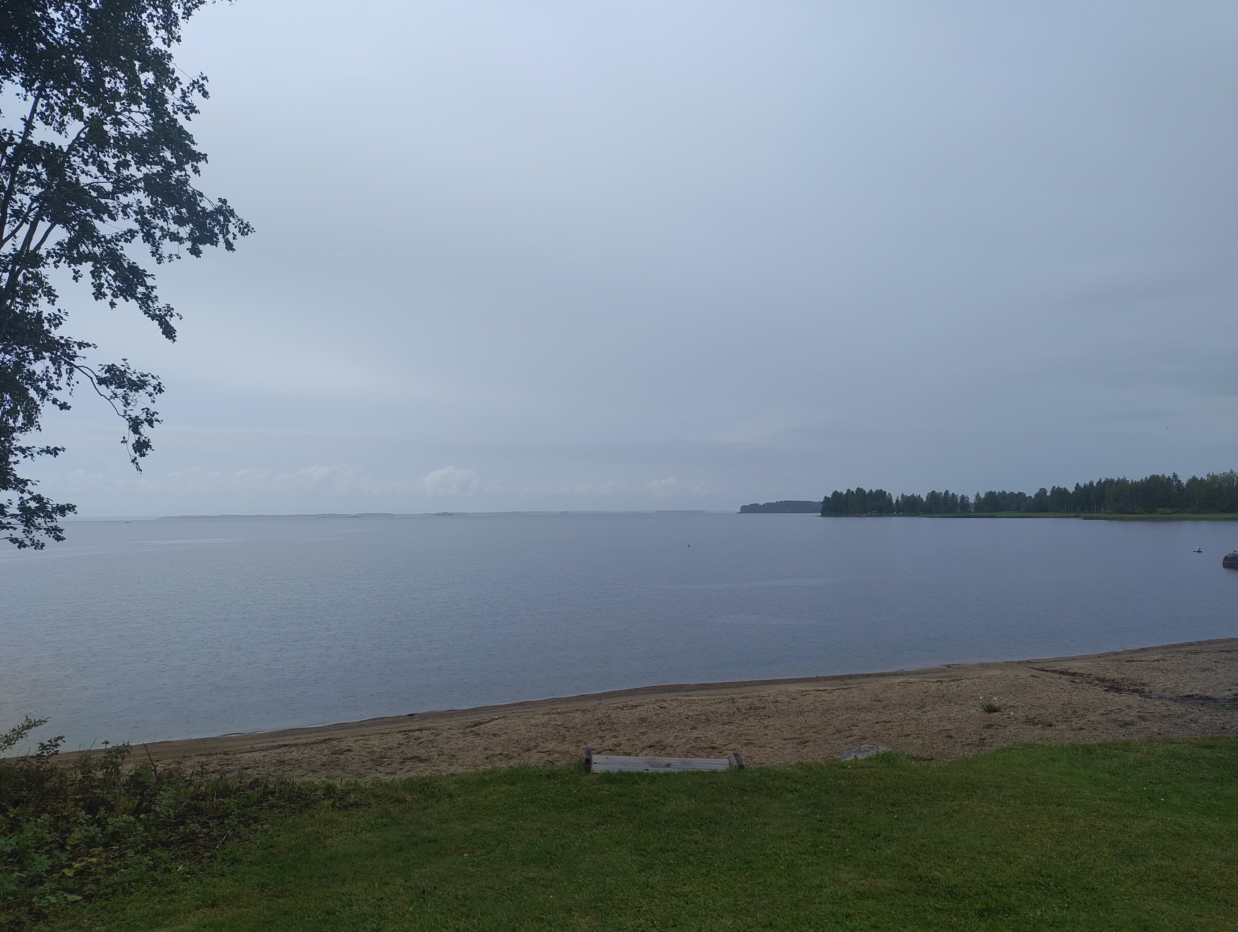 Lappajärvi harmaassa säässä. Iso ulappa, edustalla hiekkaa.